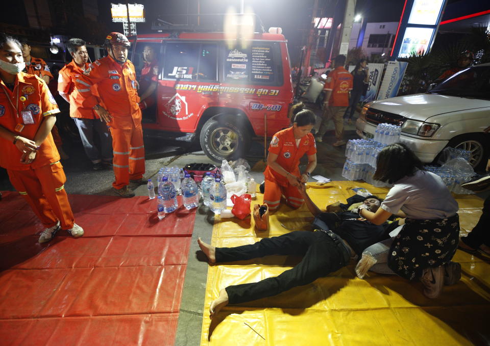 Thai rescue workers tend to an injured victim after the Terminal 21 shooting.