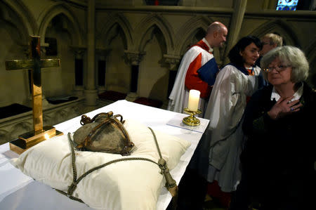 A woman looks at the 800-year-old heart of the patron Saint of Dublin Laurence O'Toole as it lies in repose returned to Christ Church Cathedral after it was stolen six years ago, in Dublin, Ireland, April 26, 2018. REUTERS/Clodagh Kilcoyne