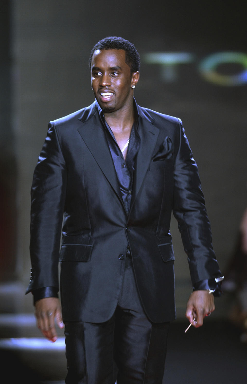 FILE - Sean "P. Diddy" Combs walks out onto the runway at the end of his Sean John Fall 2003 fashion show in New York, Feb. 8, 2003. The signs of hip-hop’s influence are now everywhere from Pharrell Williams becoming Louis Vuitton’s men’s creative director to billion-dollar brands like Dr. Dre’s Beats headphones and retail mainstays like Diddy’s Sean John and the Rocawear line started by Jay-Z. It didn’t start out that way. Companies at first balked at partnering with hip-hop acts because they felt that the genre that appealed to Black and brown teens and young adults didn't align with their brands. (AP Photo/Mark Lennihan)