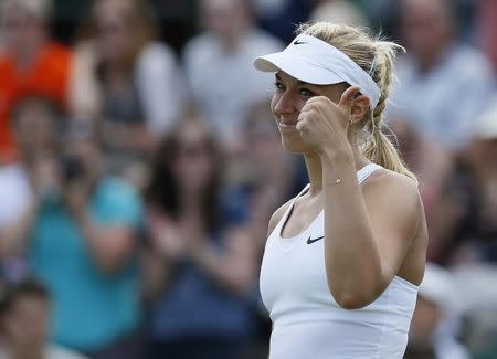 Sabine Lisicki of Germany reacts after defeating Yaroslava Shvedova of Kazakhstan in their women's singles tennis match at the Wimbledon Tennis Championships, in London July 1, 2014. REUTERS/Stefan Wermuth