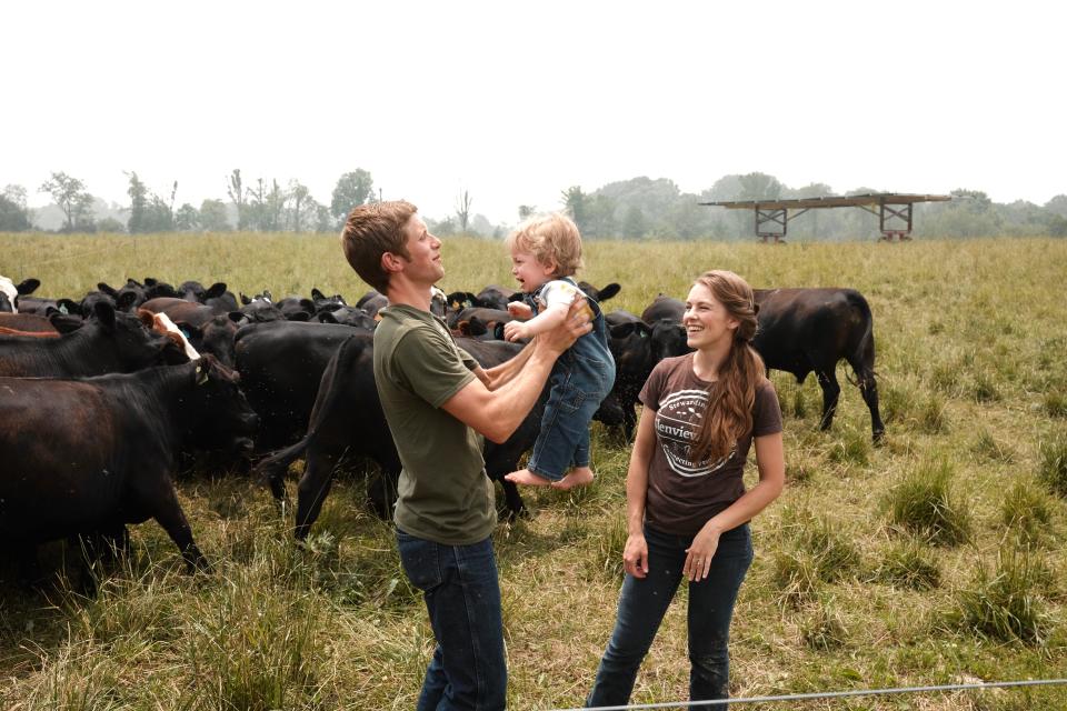 Joe and Jen Lautzenheiser try to calm their son Travis, who already loves being on the farm.