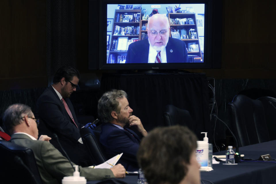 Senators and staff listen to Dr. Robert Redfield, director of the Centers for Disease Control and Prevention, speak remotely during a virtual Senate Committee for Health, Education, Labor, and Pensions hearing, Tuesday, May 12, 2020 on Capitol Hill in Washington. (Win McNamee/Pool via AP)