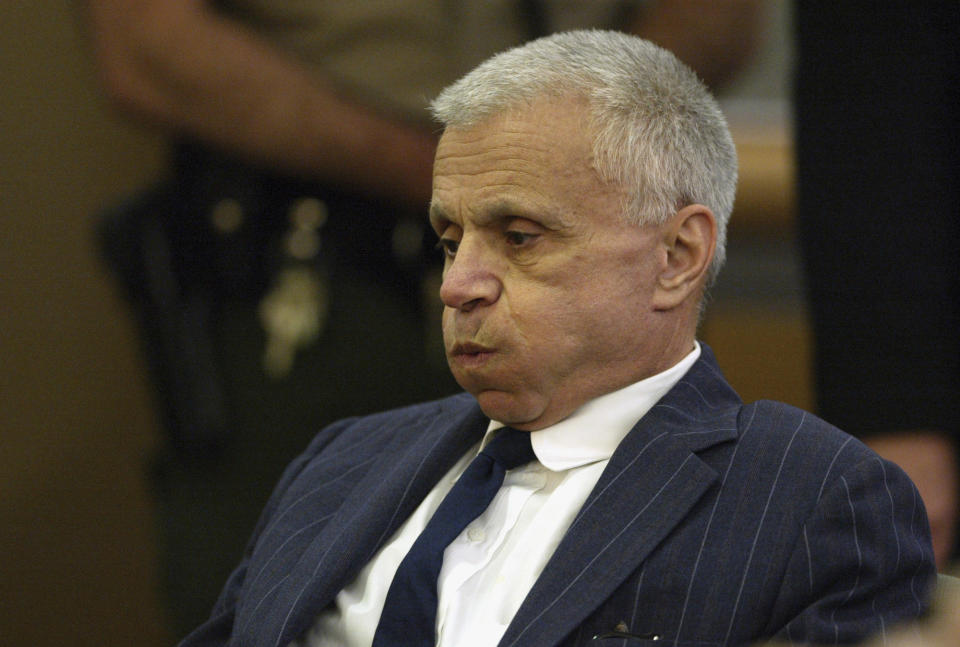 FILE - Actor Robert Blake breaths, March 27, 2003, at his arraignment inside the Van Nuys Superior Court in Los Angeles. Blake, the Emmy award-winning performer who went from acclaim for his acting to notoriety when he was tried and acquitted of murdering his wife, died Thursday, March 9, 2023, at age 89. (AP Photo/Frazer Harrison, File)