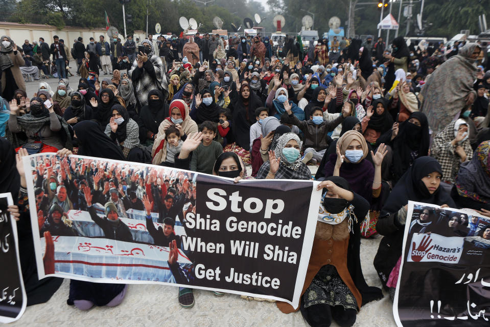 Shiite Muslims chant slogans during a sit-in to protest against the killing of coal mine workers by gunmen near the Machh coal field, in Lahore, Pakistan, Friday, Jan. 8, 2021. Pakistan's prime minister Friday appealed the protesting minority Shiites not to link the burial of 11 coal miners from Hazara community who were killed by the Islamic State group to his visit to the mourners, saying such a demand amounted to blackmailing the country's premier. (AP Photo/K.M. Chaudary)
