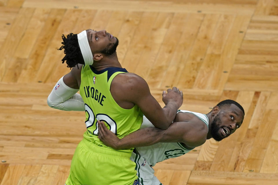 Minnesota Timberwolves forward Josh Okogie (20) fights for rebounding position with Boston Celtics guard Kemba Walker, right, in the second half of an NBA basketball game, Friday, April 9, 2021, in Boston. (AP Photo/Elise Amendola)