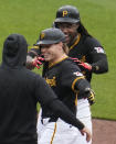 Pittsburgh Pirates' Jack Suwinski, center, celebrates with Oneil Cruz, rear, after driving in the winning run with a walkoff single off Colorado Rockies relief pitcher Nick Mears during the ninth inning of a baseball game in Pittsburgh, Saturday, May 4, 2024. (AP Photo/Gene J. Puskar)