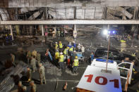 Ukrainian State Emergency Service firefighters work to extinguish a fire at a shopping center burned after a rocket attack in Kremenchuk, Ukraine, late Monday, June 27, 2022. (AP Photo/Efrem Lukatsky)