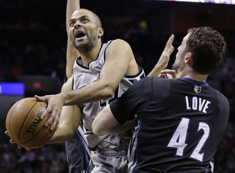 San Antonio Spurs' Tony Parker, left, of France, shoots over Minnesota Timberwolves' Kevin Love (42) during the first half of an NBA basketball game, Sunday, Jan. 12, 2014, in San Antonio. (AP Photo/Eric Gay)