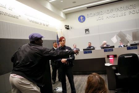 Evan Bunch throws speaker comment cards in protest of Ezell Ford's death in front of the Police Commission during a meeting of the Los Angeles Police Commission in Los Angeles, California June 9, 2015. REUTERS/Patrick T. Fallon