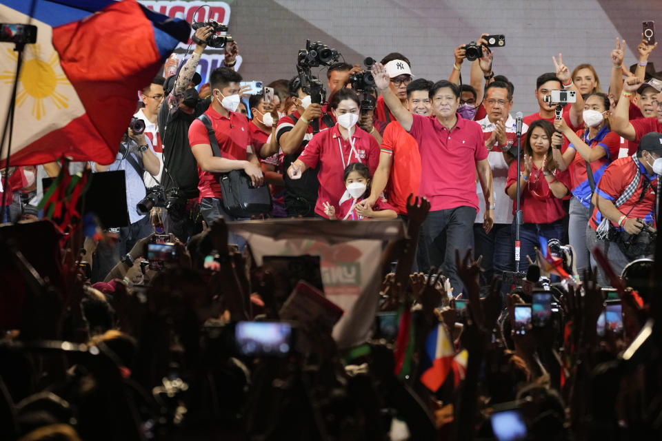 Ferdinand "Bongbong" Marcos Jr. waves to the crowd during a campaign rally in Quezon City, Philippines on April 13, 2022. Marcos Jr., son of the late dictator and his running mate Sara, who is the daughter of the outgoing President Rodrigo Duterte, are leading pre-election surveys despite his family's history. (AP Photo/Aaron Favila)