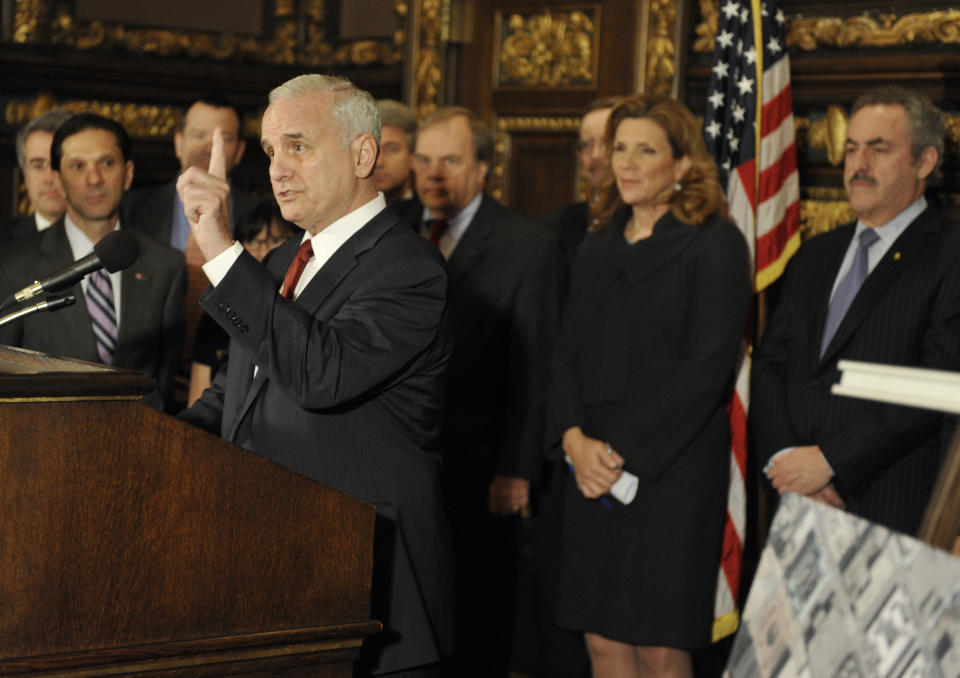 Minnesota Gov. Mark Dayton, left, emphasizes that an agreement for a new Minnesota Vikings NFL football stadium will require no general fund tax dollars as Vikings owner Zygi Wilf, right, and other lawmakers listen during a news conference Thursday, March 1, 2012 in St. Paul , Minn. where it was announced that a site for a new Vikings football stadium along with a financing agreement had been reached. (AP Photo/Jim Mone)