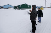 FILE - In this Jan. 20, 2020, file photo, census workers verify that their maps match up to the right amount of houses in Toksook Bay, Alaska, a mostly Yup'ik village on the edge of the Bering Sea. Alaska's population grew by 23,160 people, or 3.3%, in the last decade, according to the first numbers released Monday for the 2020 Census. (AP Photo/Gregory Bull, File)