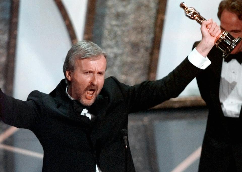 James Cameron accepting the Best Director Oscar for Titanic at the 70th Academy Awards in Los Angeles Monday, March 23, 1998. Titanic also won for Best Picture. (AP Photo/Susan Sterner)