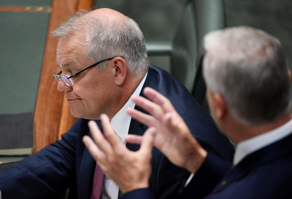 CANBERRA, AUSTRALIA - MARCH 03: Prime Minister Scott Morrison listens to Deputy Prime Miniser Michael McCormack during Question Time on March 03, 2020 in Canberra, Australia. The Reserve Bank has cut interest rates to 0.05% as the Federal Government works on plans to safeguard the Australian economy amid the current coronavirus outbreak. (Photo by Tracey Nearmy/Getty Images)