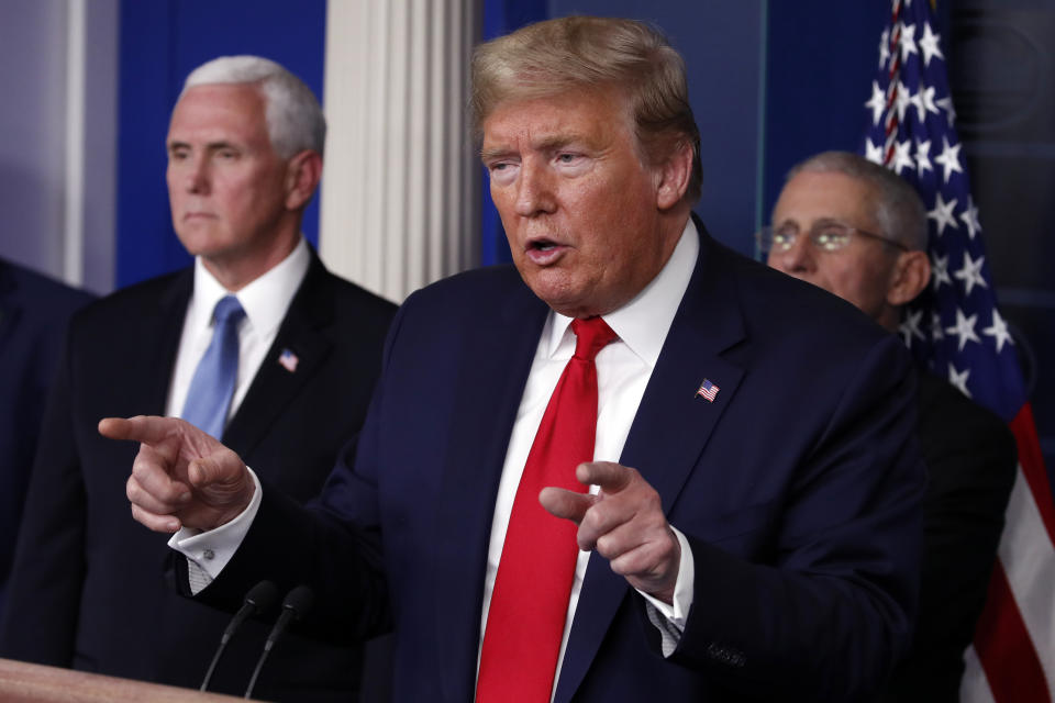 President Donald Trump speaks about the coronavirus in the James Brady Briefing Room, Tuesday, March 24, 2020, in Washington, as Vice President Mike Pence and Dr. Anthony Fauci, director of the National Institute of Allergy and Infectious Diseases, listen. (AP Photo/Alex Brandon)