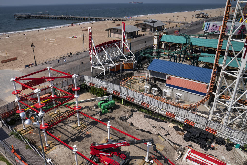 Construction is underway in the amusement park district of Coney Island, Friday, June 17, 2022, in the Brooklyn borough of New York. Luna Park in Coney Island will open three new major attractions this season alongside new recreational areas and pedestrian plazas. (AP Photo/John Minchillo)