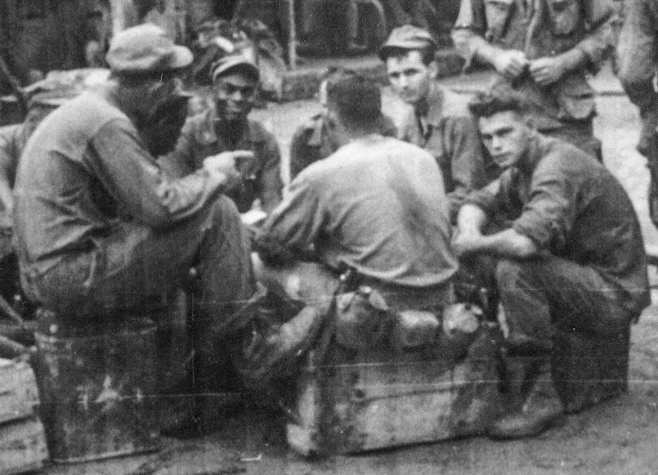 Fred Norris (second from left) sits next to friend and fellow mortarman Robert Pipkins during a game of poker. The crew was backup for Gen. Westmoreland's security. "We were there just in case," Norris said. "It was a nice break from the day to day."