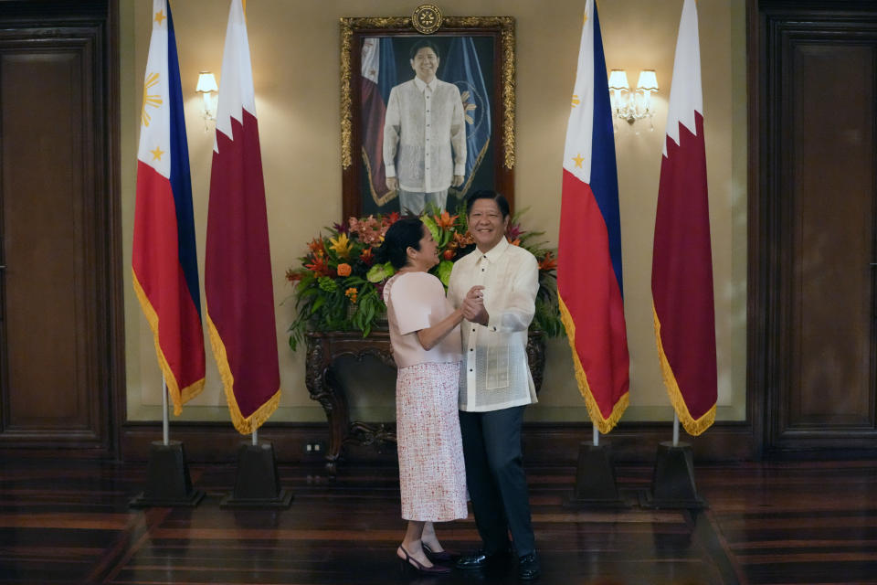 Philippine President Ferdinand Marcos Jr., right, briefly dances with First Lady Liza as they wait for Emir of Qatar, Sheikh Tamim Bin Hamad Al Thani at Malacanang Presidential palace Monday, April 22, 2024, in Manila, Philippines. (AP Photo/Aaron Favila, Pool)