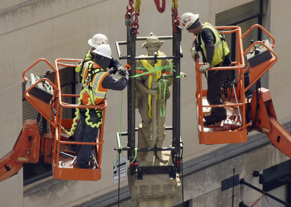 FILE - Workers secure the top portion of the Confederate monument as they prepare to remove it from the corner of Fourth and Liberty streets in Winston-Salem, N.C., on Tuesday, March 12, 2019. On Friday, Dec. 16, 2022, North Carolina's Supreme Court ruled that the local chapter of United Daughters of the Confederacy lacks standing to challenge the city of Winston-Salem's removal of the Confederate monument on private property, but it can refile a future lawsuit making similar arguments. (Walt Unks/Winston-Salem Journal via AP, File)