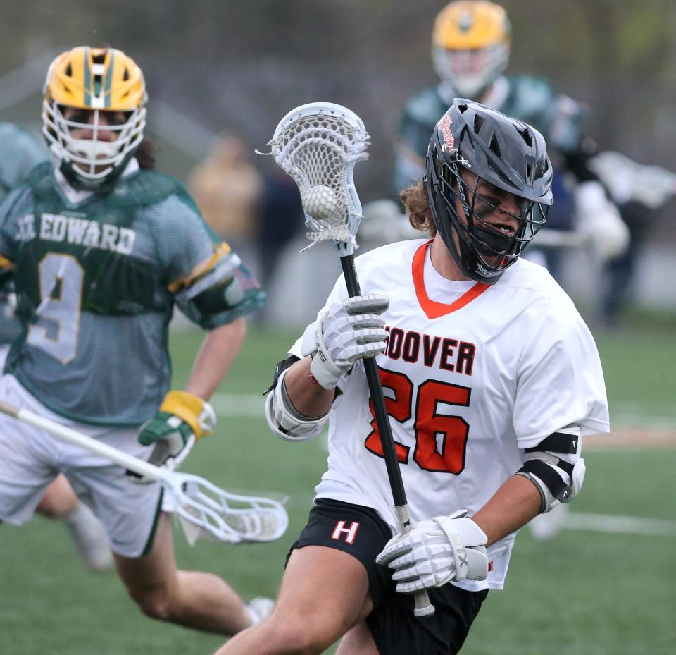 Ethan Rebholz, 26, of Hoover brings the ball upfield while being trailed by Dom Florio, 9, of St. Edward during their game at Hoover on Tuesday, April 26, 2022.