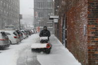 <p>A maintenance worker clears the sideways outside a mall in the DUMBO section of Brooklyn, New York as a spring storm hit the area on March 21, 2018. (Photo: Gordon Donovan/Yahoo News) </p>