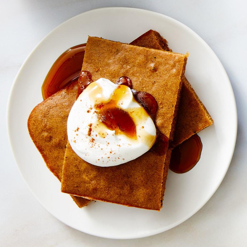 gingerbread latte sheet pan pancake with whipped cream maple syrup and powdered sugar