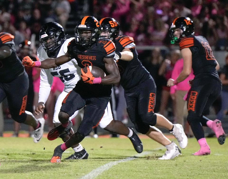 Spruce Creek's Tony Kinsler (2) scampers for yardage during a game with New Smyrna Beach at Spruce Creek High School in Port Orange, Friday, Oct. 20, 2023.
