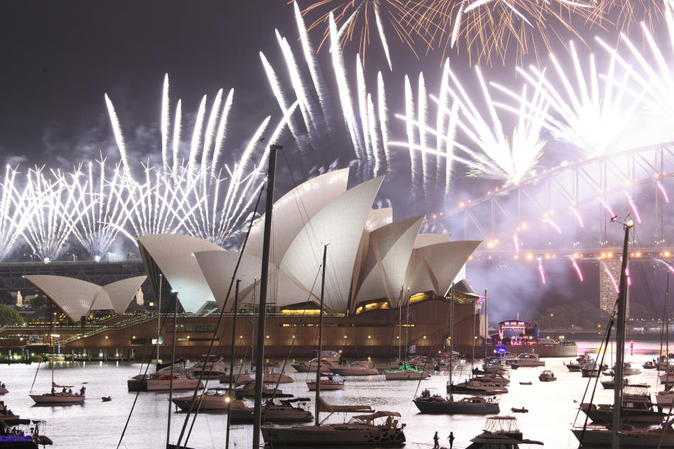 SYDNEY, AUSTRALIA - JANUARY 01: A fireworks display is seen over the Sydney Opera House during New Year's Eve celebrations on January 01, 2021 in Sydney, Australia. Celebrations look different this year as COVID-19 restrictions remain in place due to the ongoing coronavirus pandemic. (Photo by Wendell Teodoro/Getty Images)