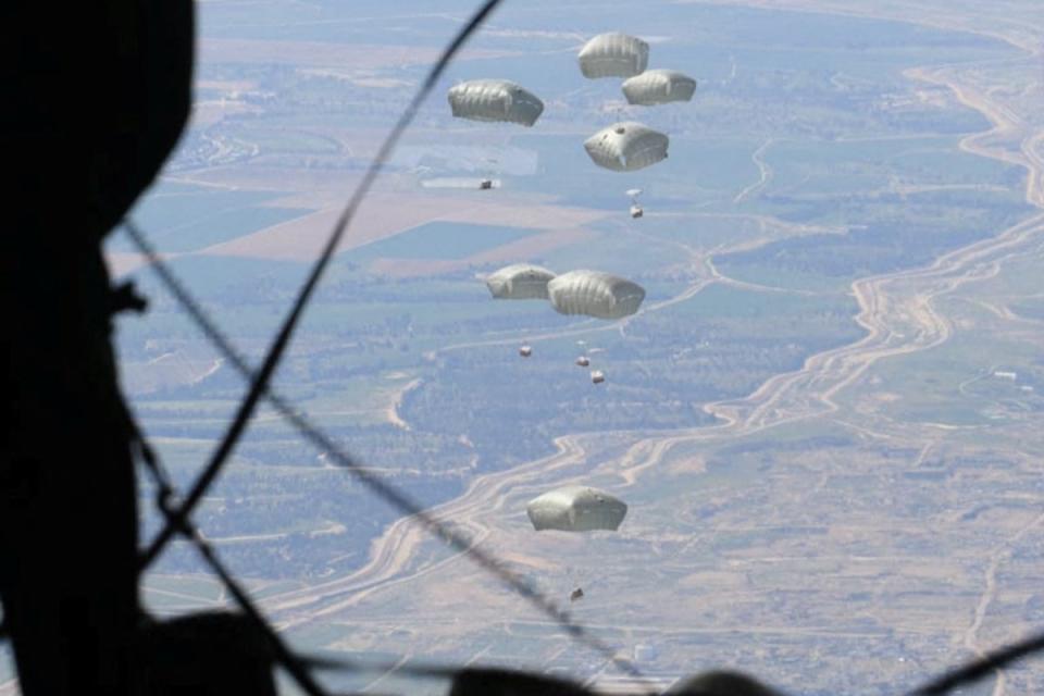 Jordanian Armed Forces members airdrop aid parcels to several areas in northern Gaza (via Reuters)