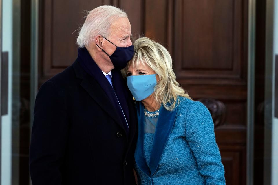 US President Joe Biden (C L) hugs First Lady Jill Biden as they arrive at the White House in Washington, DC, on January 20, 2021.