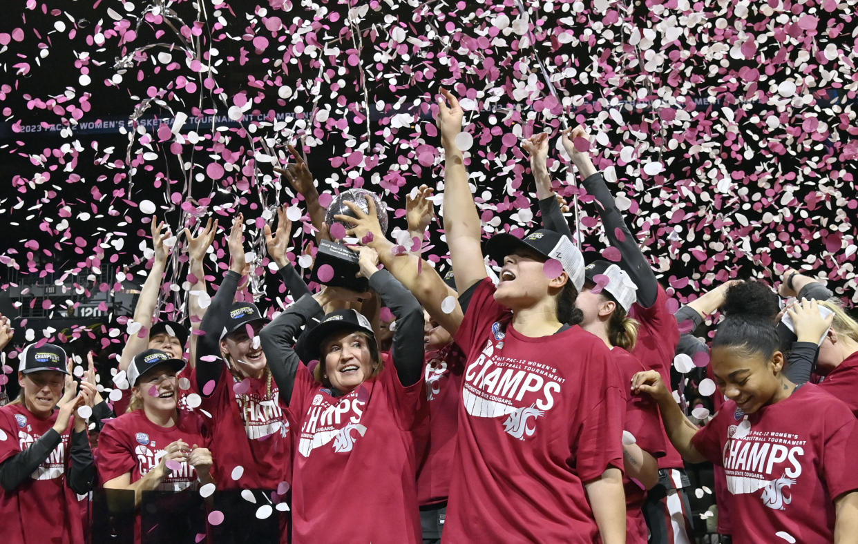 Washington State head coach Kamie Ethridge, center left, Ula Motuga, center right, and the team celebrate after winning the Pac-12 tournament title on March 5, 2023, in Las Vegas. (AP Photo/David Becker)