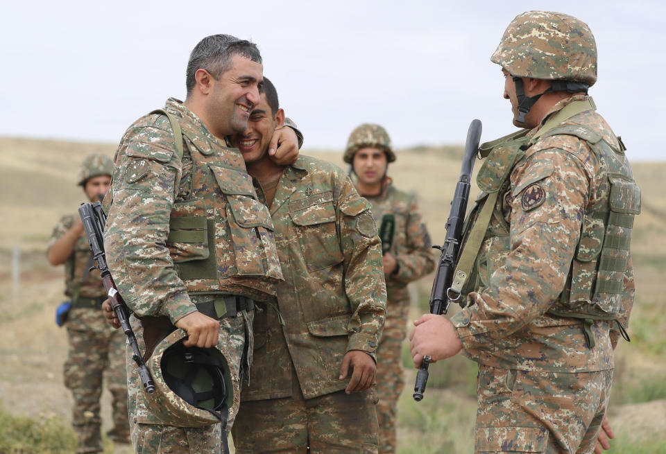 Armenian servicemen react, at their position in the self-proclaimed Republic of Nagorno-Karabakh, Azerbaijan, Tuesday, Sept. 29, 2020. Armenian and Azerbaijani forces accused each other of attacks on their territory Tuesday, as fighting over the separatist region of Nagorno-Karabakh continued for a third straight day following the reigniting of a decades-old conflict. (Sipan Gyulumyan/Armenian Defense Ministry Press Service/PAN Photo via AP)