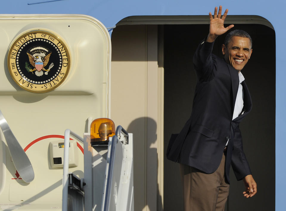 President Barack Obama waves while boarding Air Force One before leaving O'Hare International Airport in Chicago, June 17, 2012. (AP Photo/Paul Beaty)