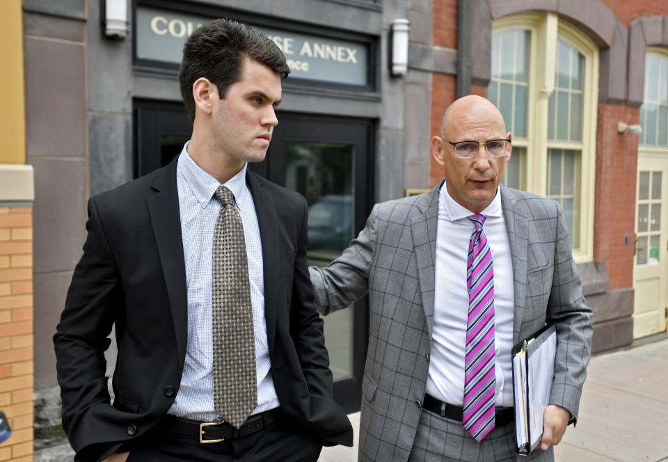 FILE – In this June 13, 2018, file photo, Ryan Burke, left, who was a fraternity brother at Penn State University's shuttered Beta Theta Pi chapter, walks with his attorney Philip Masorti on the day Burke pleaded guilty to four counts of hazing and five alcohol-related offenses related to the death of 19-year-old fraternity pledge Timothy Piazza, of Lebanon, N.J., outside the Centre County Courthouse Annex in Bellefonte, Pa. Burke is set to learn his sentence, on Tuesday, July 31. (Abby Drey/Centre Daily Times via AP, File)