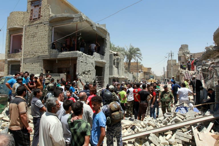 Iraqi emergency personnel inspect the damage after a warplane accidentally dropped a bomb on the al-Jadidah neighborhood of Baghdad, on July 6, 2015