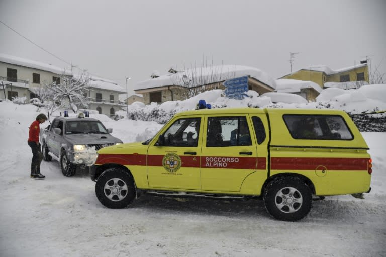 Emergency vehicles wait in the snow in Montereale's main street, near Amatrice, after a 5.7-magnitude earthquake struck the region, on January 18, 2017