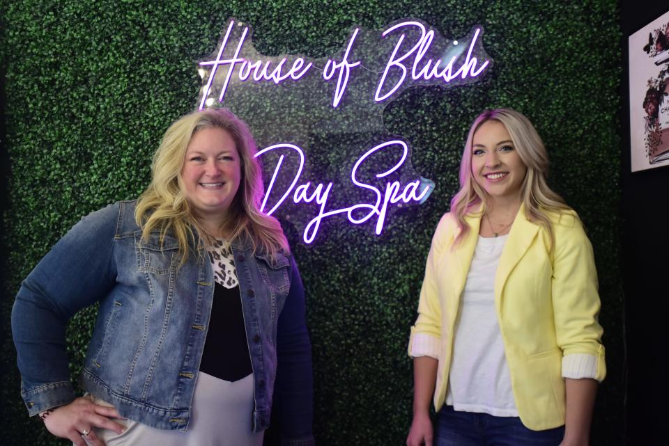 Annette Piontkowski (left) and Carmen Sadlowski (right) pose by the neon sign that hangs behind the check-in counter inside the new House of Blush Day Spa on 3rd St., in downtown St. Clair on Friday, June 10, 2022. The two old friends attended Lakewood School of Therapeutic Massage many years ago and have teamed up to open their new spa in St. Clair.