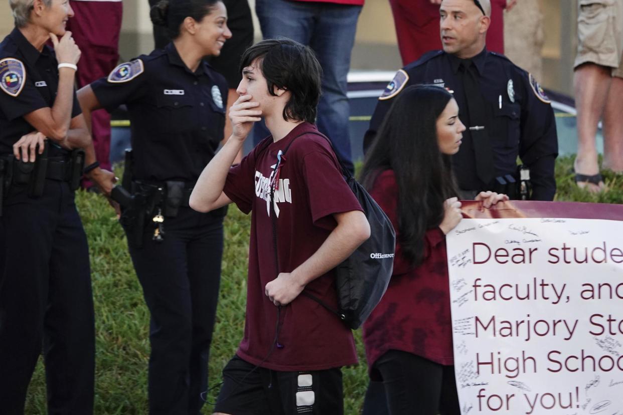 A returning student reacts as he walks to Marjory Stoneman Douglas High School: AP
