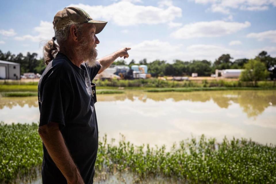 Larry Smitherman Sr. points to his neighbor’s property where a concrete batch plant application was submitted to the TCEQ along Gibson Cemetery Road in Mansfield. Smitherman’s property has a large pond where his grandchildren play at often.