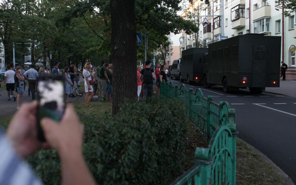 Police vans drive past a rally - Maxim S.