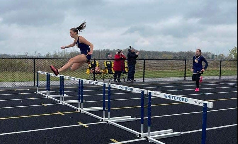 Annabelle Gapp and teammate Jessica Ulery run the hurdles during a 70-67 Whiteford win over Adrian Madison Tuesday. The Bobcats snapped Madison's 107-meet winning streak in the Tri-County Conference.