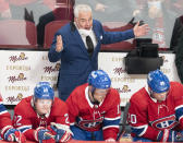 Montreal Canadiens coach Dominique Ducharme argues a call as Canadiens' Cole Caufield (22), Brendan Gallagher (11) and Chris Wideman (20) sits on the bench during the third period of the team's NHL hockey game against the San Jose Sharks on Tuesday, Oct. 19, 2021, in Montreal. (Ryan Remiorz/The Canadian Press via AP)