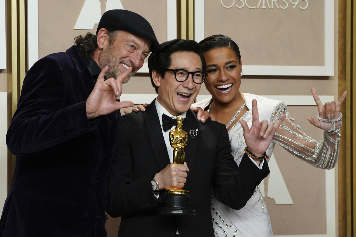 Ke Huy Quan, center, winner of the award for best performance by an actor in a supporting role for "Everything Everywhere All At Once" poses with Troy Kotsur, left, and Ariana DeBose in the press room at the Oscars on Sunday, March 12, 2023, at the Dolby Theatre in Los Angeles. (Photo by Jordan Strauss/Invision/AP)