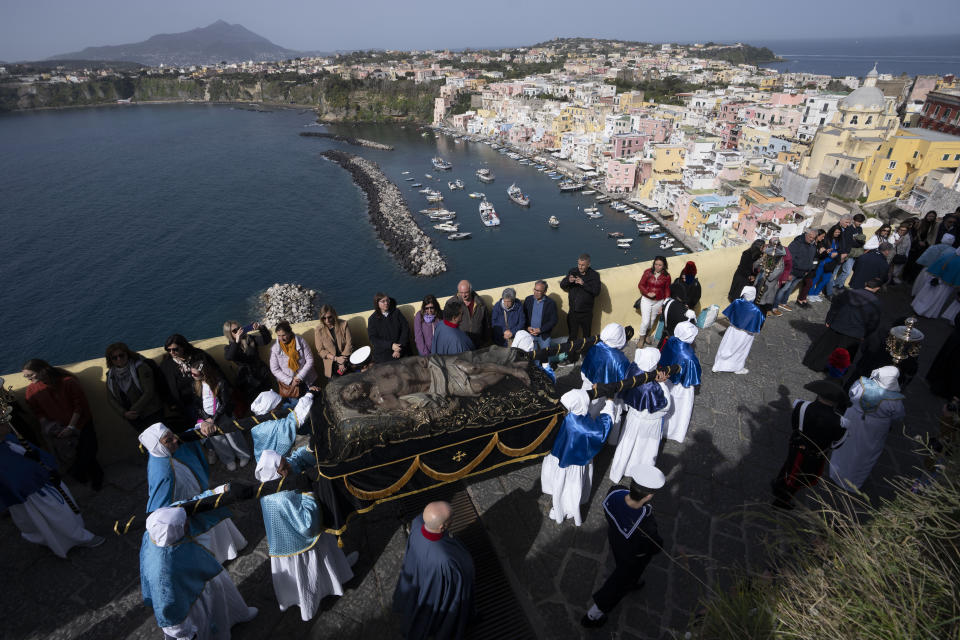 Faithful carry an 18th century wooden Christ during a procession on Procida Island, Italy, Friday, March 29, 2024. Italy is known for the religious processions that take over towns big and small when Catholic feast days are celebrated throughout the year. But even in a country where public displays of popular piety are a centuries-old tradition, Procida's Holy Week commemorations stand out. (AP Photo/Alessandra Tarantino)
