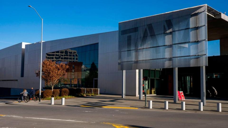 Cyclists ridge north on Pacific Avenue past the Tacoma Museum of Art on Friday, Dec. 16, 2022, in Tacoma, Wash. Pete Caster/Pete Caster / The News Tribune