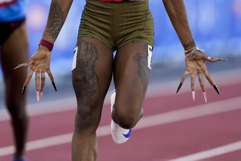 Sha'Carri Richardson, shows her long finger nails, as she wins a heat women's 100-meter run during the U.S. Track and Field Olympic Team Trials Friday, June 21, 2024, in Eugene, Ore. (AP Photo/Charlie Neibergall)