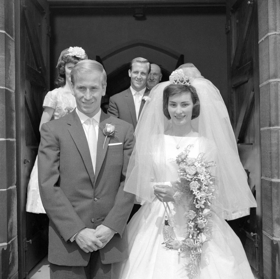 FILE - Bobby Charlton, the Manchester United and England football star, and his bride, twenty-one-year-old fashion model Norma Ball, leave St. Gabriel's church in Middleton, near Manchester, England, after their wedding, July 22, 1961. Bobby Charlton, an English soccer icon who survived a plane crash that decimated a Manchester United team destined for greatness to become the heartbeat of his country's 1966 World Cup-winning team, has died. He was 86. A statement from Charlton's family, released by United, said he died Saturday Oct. 21, 2023 surrounded by his family. (AP Photo/File)