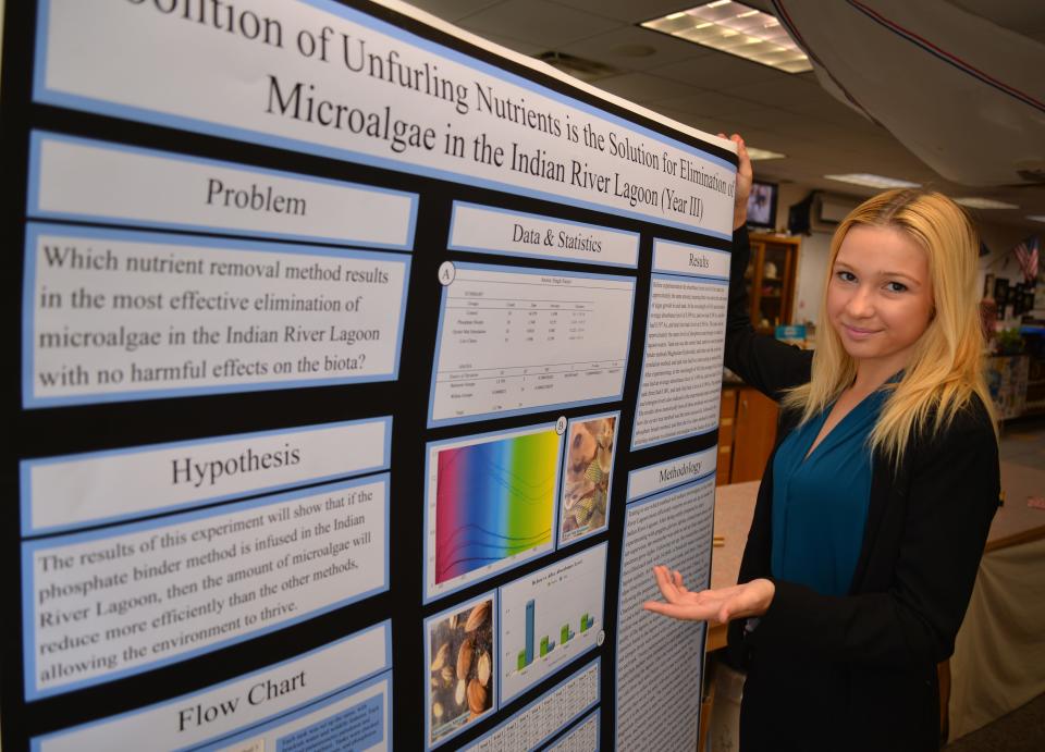 Erin Gaydar, a senior at Edgewood Jr./Sr. High School on Merritt Island, displays the science fair project  that took first-place honors at the state level and got her a bid to the International Science and Engineering Fair in Atlanta. Her project deals with eliminating microalgae in the Indian River Lagoon.