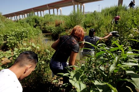 FILE PHOTO: Migrants from Cuba are seen on the banks of the Rio Bravo river as they cross illegally into the United States to turn themselves in to request asylum in El Paso, Texas, as seen from Ciudad Juarez