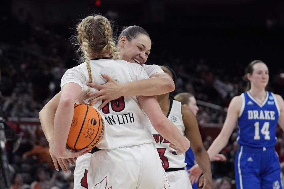 Louisville guard Hailey Van Lith (10) is hugged by teammate Mykasa Robinson after their win over Drake in the first round of the NCAA Tournament in Austin, Texas, Saturday, March 18, 2023. (AP Photo/Eric Gay)